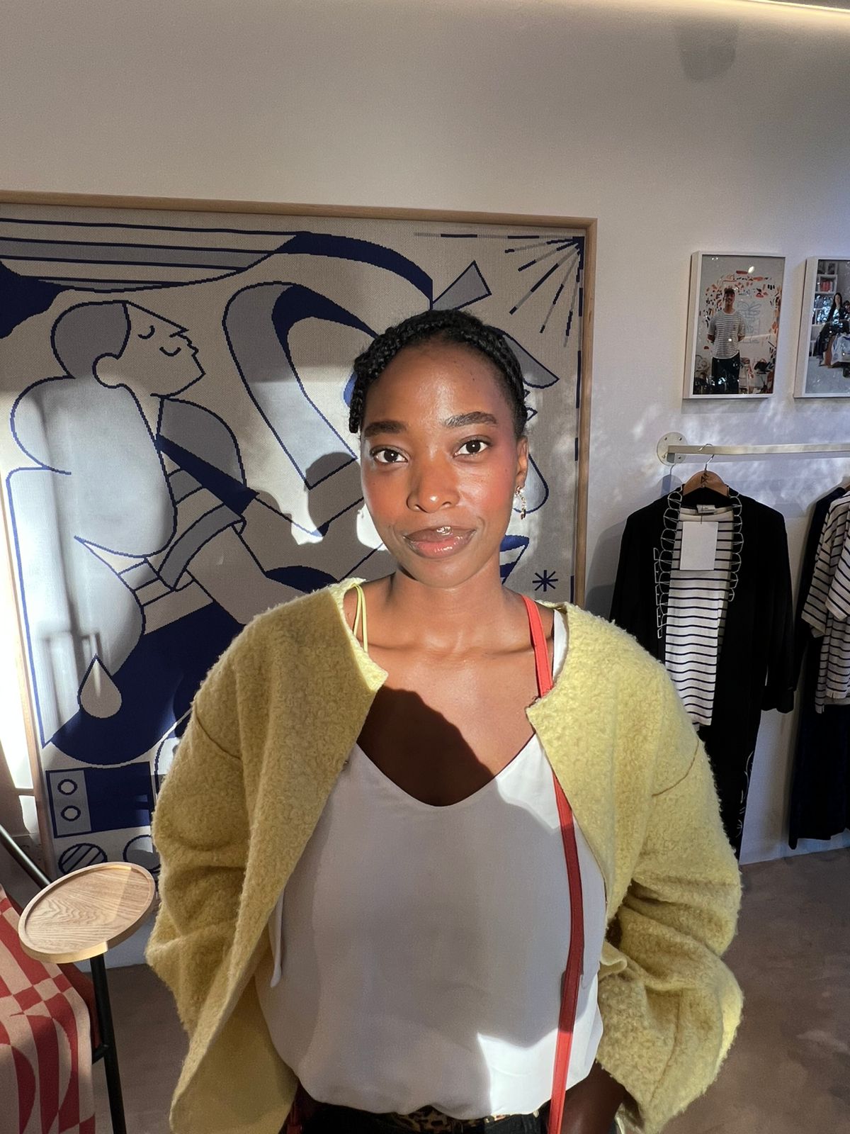 Tshego in a butter-yellow cardigan, looking straight at the camera
